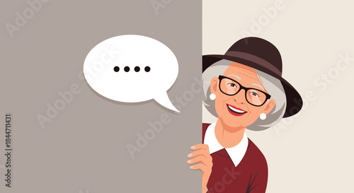 Happy elderly woman with glasses and a hat peeking from behind a wall with a blank speech bubble for your custom text.
