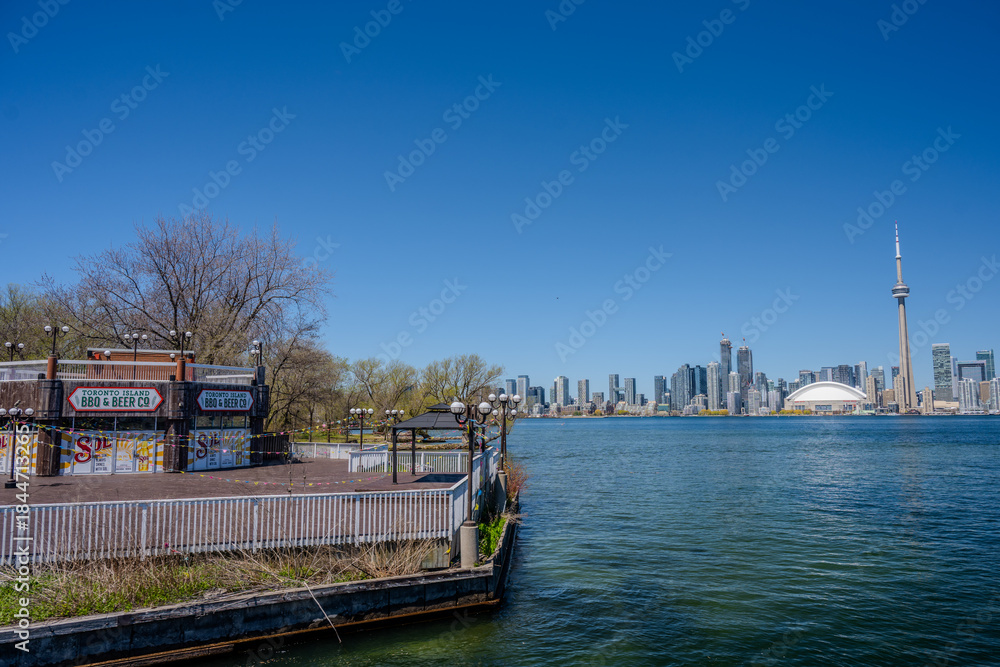 Fototapeta premium Waterfront patio and skyline view of Toronto across the harbor