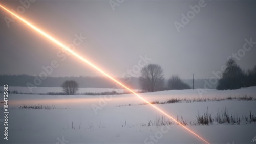 Bright orange light ray streaking across a snow-covered field on a gloomy winter day