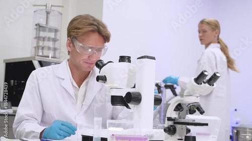 Research team works in laboratory with microscopes and samples