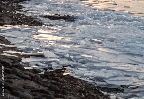 Layers of cracked ice on lakeside