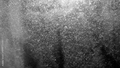 Slika na platnu A black and white macro shot of a textured surface with myriad droplets, possibly ice or condensation, illuminated by strong light