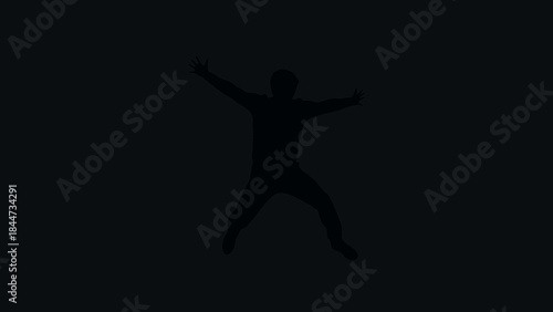 Silhouette of a person jumping freely.