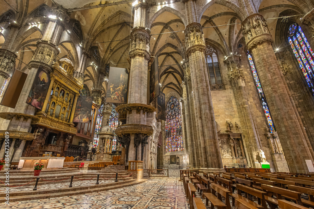 Fototapeta premium Grand Milan Gothic Cathedral Interior With Stained Glass, Altars, and Ornate Pulpit for Stock Image