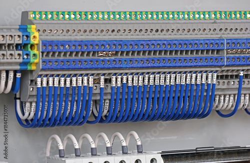 Electrical screw terminals for connecting wires in an electrical switchboard. Soft focus. Close-up.