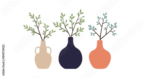 A modern minimalist composition of three stylish ceramic vases in neutral colors each holding a delicate branch with green leaves.