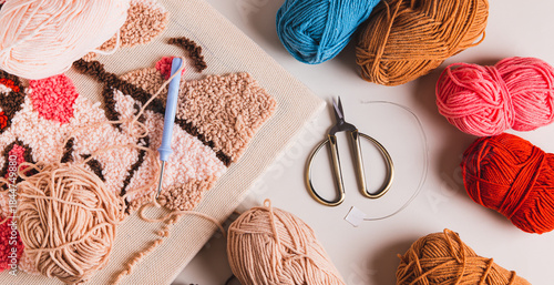 Punch needling kit, threads, canvas and needle for handmade crafts top view web banner