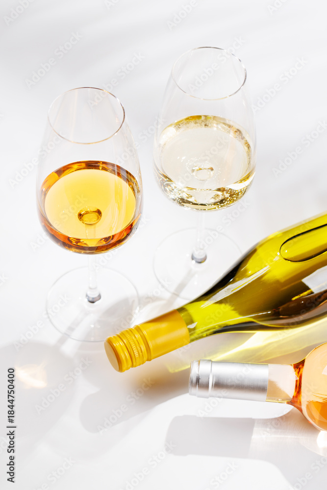 Obraz premium Different wine bottles and glasses on white background