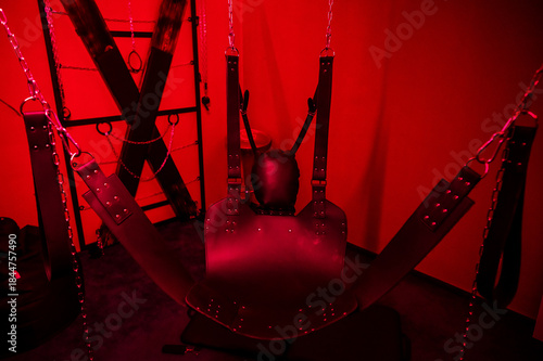 Fotografie Sex swing in red light. BDSM equipment.