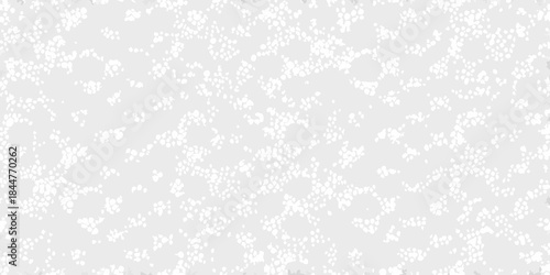 Abstract white dotted pattern on a gray background creating a textured effect