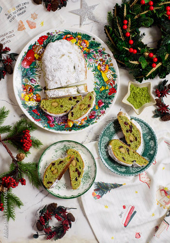 Traditional Christmas Stollen with matcha tea on a Christmas rustic background