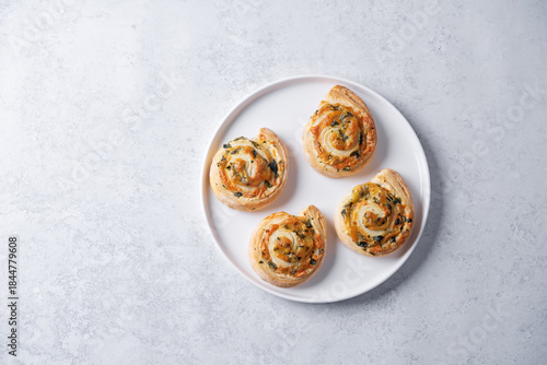 Basil garlic cheese roll cake pinwheel in a plate on a white isolated background