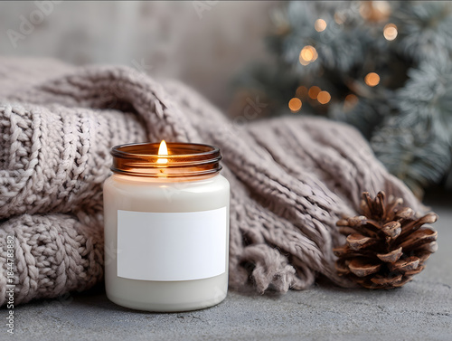 close up photo of a cozy mockup of a lit amber jar candle with a white empty label in a cozy Christmas festive atmosphere people gathered around the Christmas tree.jp
