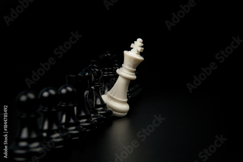 Wallpaper Mural White chess king standing alone against opposing black pieces representing resistance, disruption, minority challenge, and strategic defiance in competitive or business environments. Torontodigital.ca