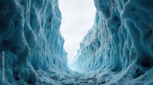 Path leading through a stunning blue glacial ice canyon walls