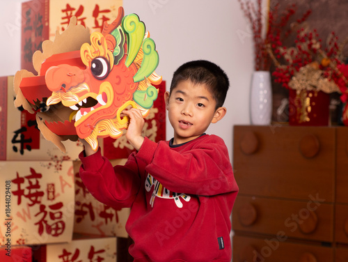 Chinese children perform dragon dance for Chinese New Year.