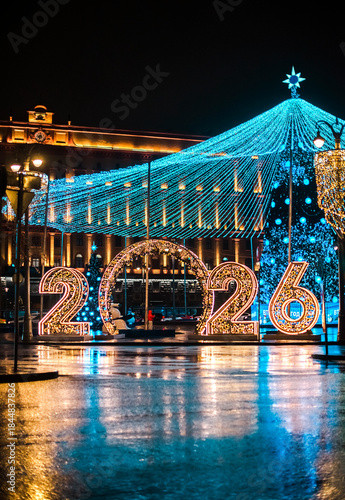 A glowing installation of 2026 at night on the city's streets.