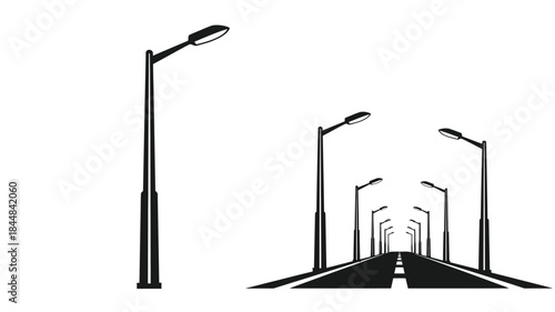 A long road receding into the distance with street lamps silhouette