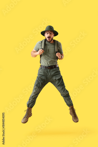 Jumping male traveler on ye...