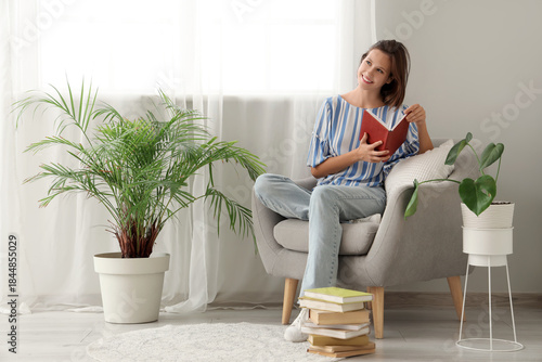 Young woman reading book in...
