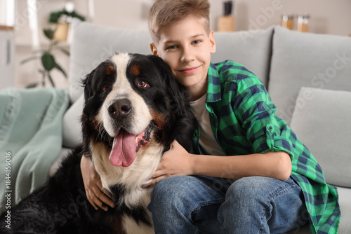 Boy with cute fluffy dog si...