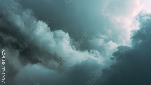 Dark and billowing storm clouds dominate the sky creating a striking contrast with lighter patches. The atmosphere feels charged hinting at a forthcoming storm or rainstorm.