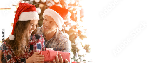 Cute young couple in Santa ...