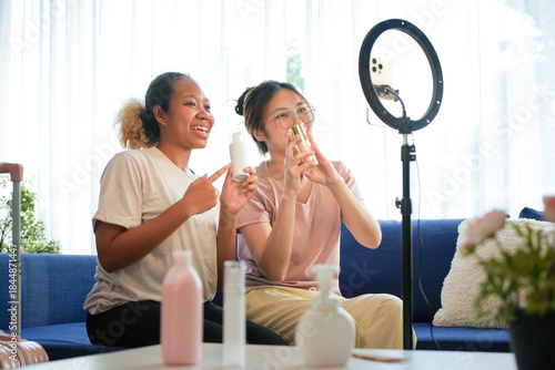 Diverse Beauty Bloggers Live Streaming Makeup Product Review on Social Media, Young Women Recording Video for Vlogging Channel with Ring Light, Friends Selling Cosmetic Products Online from Home