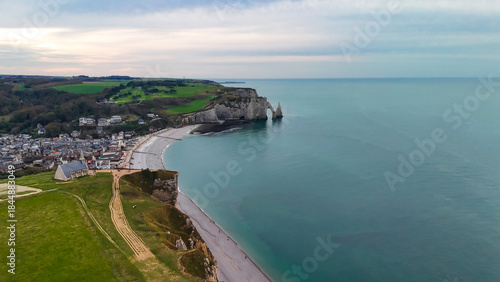 Aerial drone view of picturesque coastal limestone cliffs and the English Channel town of Etretat, France