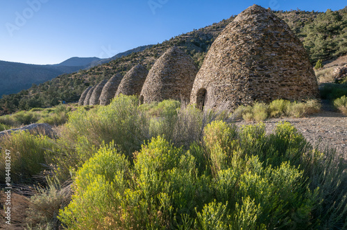 Historical Conical Stone Wildrose Kilns Against Desert Mountain Backdrop