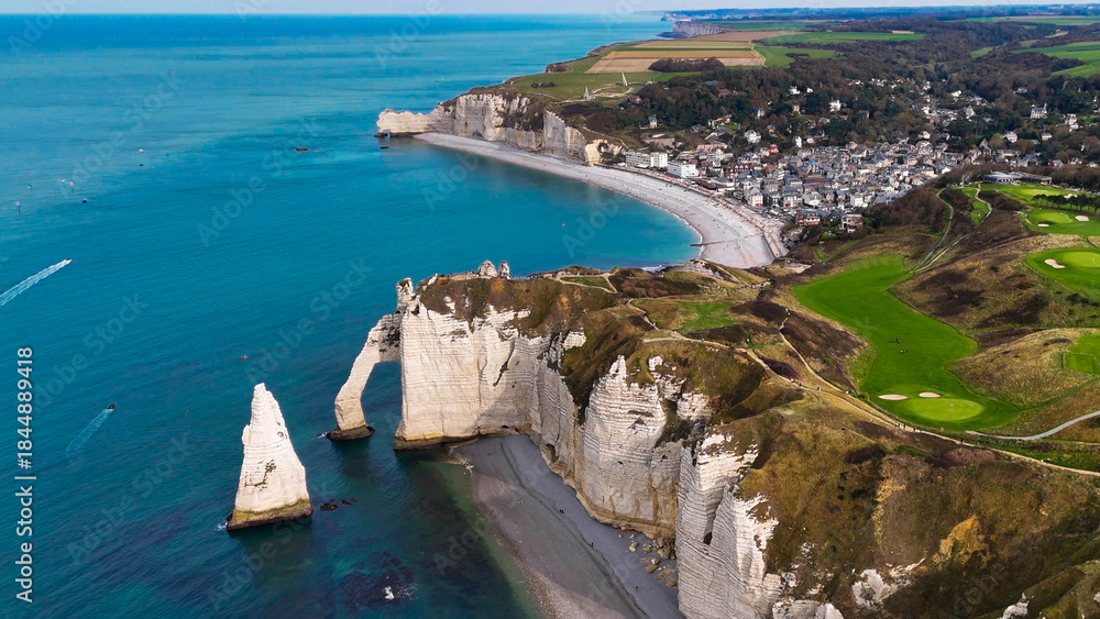 Fototapeta premium Aerial drone view of picturesque coastal limestone cliffs and the English Channel town of Etretat, France