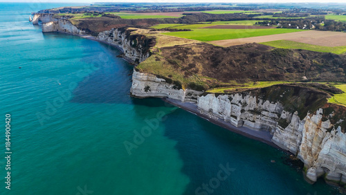 Aerial drone view of picturesque coastal limestone cliffs and the English Channel town of Etretat, France