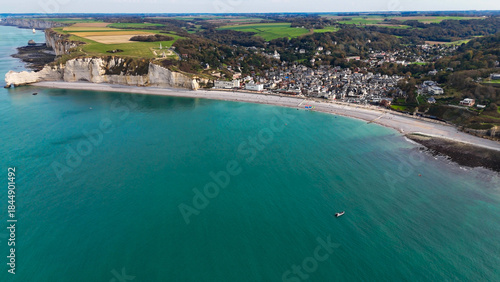 Aerial drone view of picturesque coastal limestone cliffs and the English Channel town of Etretat, France
