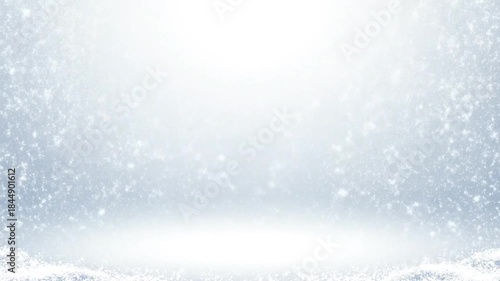 Snowfall scene with a bright light shining through snowflakes against a white background.