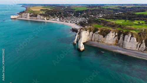 Aerial drone view of picturesque coastal limestone cliffs and the English Channel town of Etretat, France