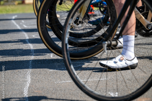 Photography The starting line of a bicycle race, showing front wheels and feet - horizontal