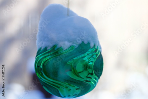Large, Snow-Covered Christmas Ornament on a Outdoor Tree