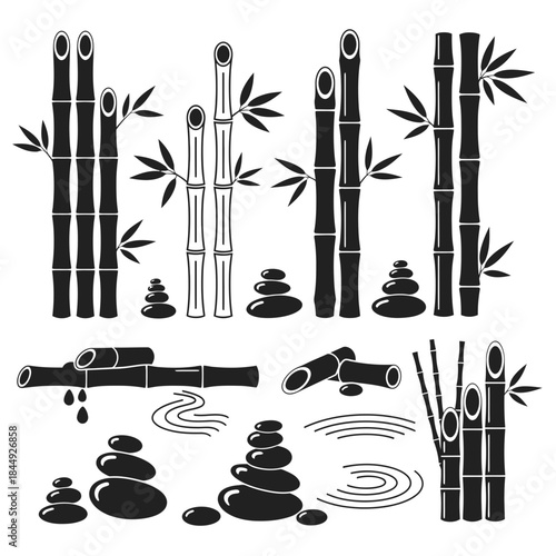Stunning collection of black and white bamboo stalks and serene stacked zen stones for spa design