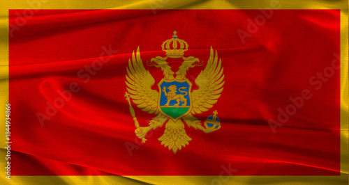 Flag of Montenegro with fabric textured background. Close up of National flag of Montenegro with realistic texture
