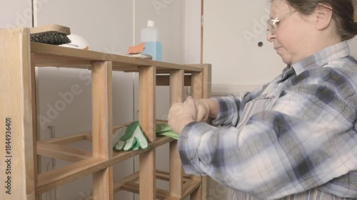 Female artisan fixing vintage dresser in workshop, Craftswoman cleaning old furniture, restoring antique chest drawers, vintage trade, artisan touch, selling for collectors