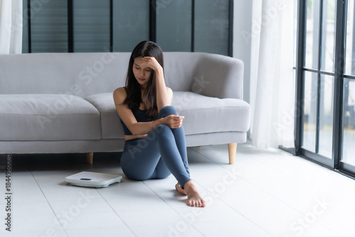 Photos Sad woman with fat upset bored of dieting Weight loss fail  Fat diet and scale sad asian woman on weight scale at home weight control
