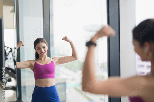 Healthy Young Hispanic Gen Z Woman in Sportswear Shaping Body for Confidence and Weight Loss at Gym.