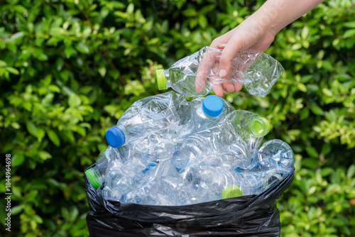 Plastic bottles in black garbage bags waiting to be taken to recycle.