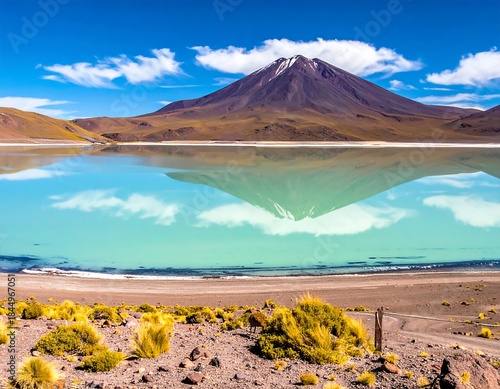 Stunning reflection of a mountain in a turquoise lake under a bright blue sky
