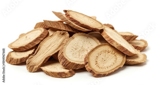 Pile of dried astragalus root slices isolated on white background