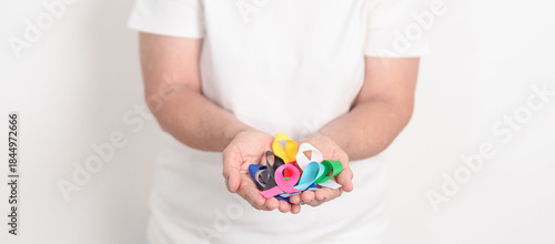 World cancer day, February 4. Elderly with colorful ribbons, blue, yellow, red, green, white, pink and grey for supporting people living and illness. Health, Medical, awareness and Insurance concept