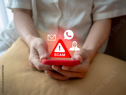Schilderij op canvas Person holding smartphone showing 3d red scam warning sign with scammer icon, calling and message symbols, representing mobile scam attacks, phishing, fraud detection, and online security awareness