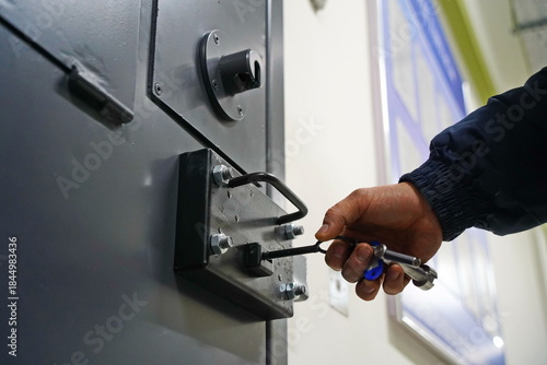 An employee of the colony closes the cell for prisoners.