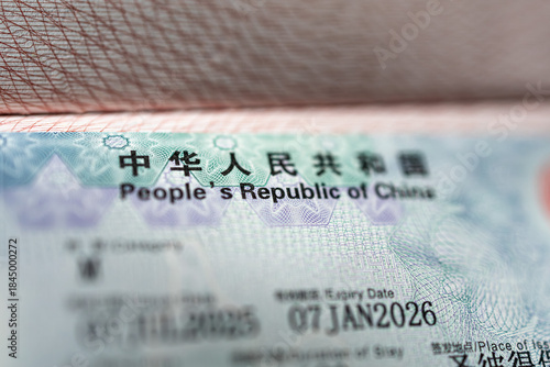 Close-up of Chinese visa in international passport. Security features and official entry permit details.