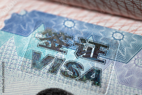Visa stamps on passport: Close-up of VISA imprints. Travel and immigration documentation.